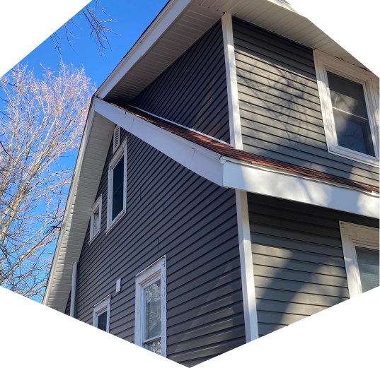 A side-angled view of a house with vinyl siding