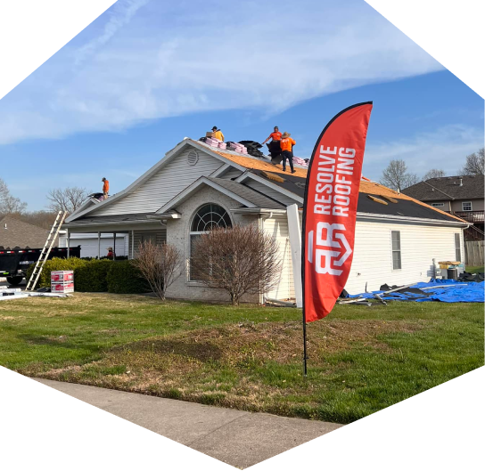 Roofing work in progress on house by Resolve Roofing Company