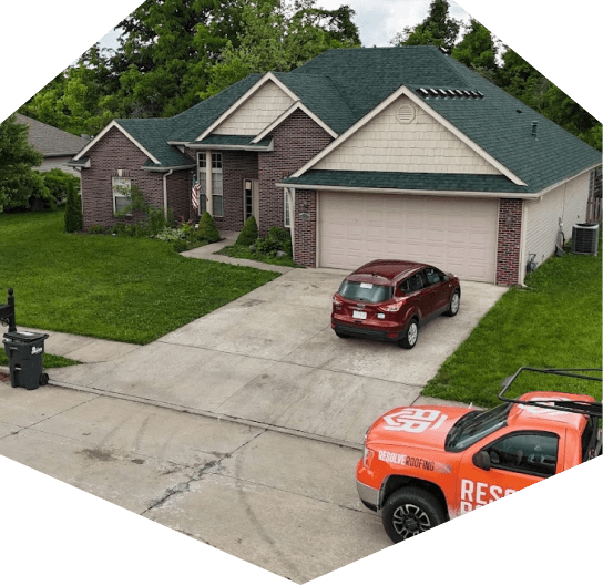 House with green roof and driveway