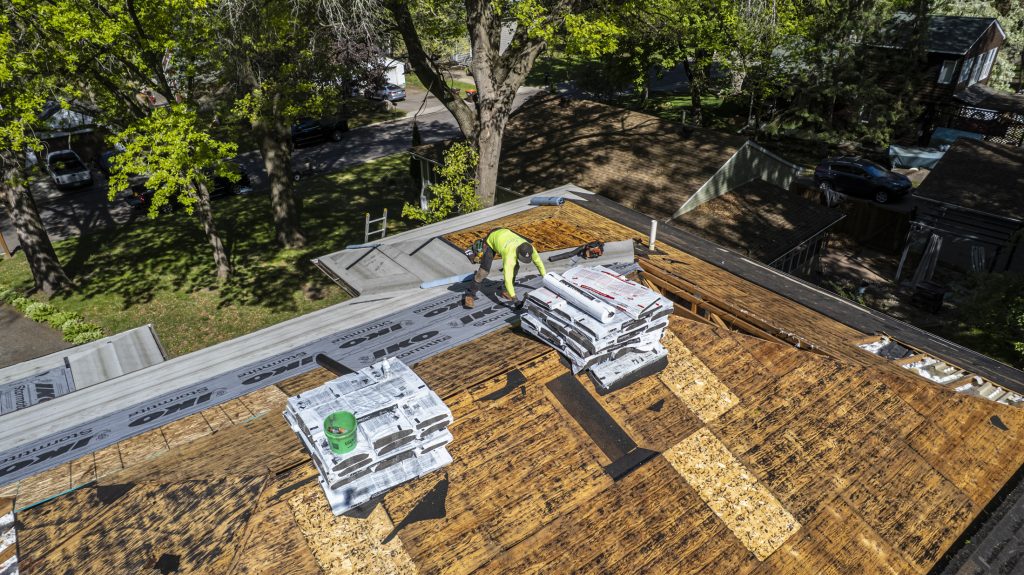 Asphalt shingles still wrapped up, as seen in a blog answering, "How many bundles of shingles in a square for roofing?"